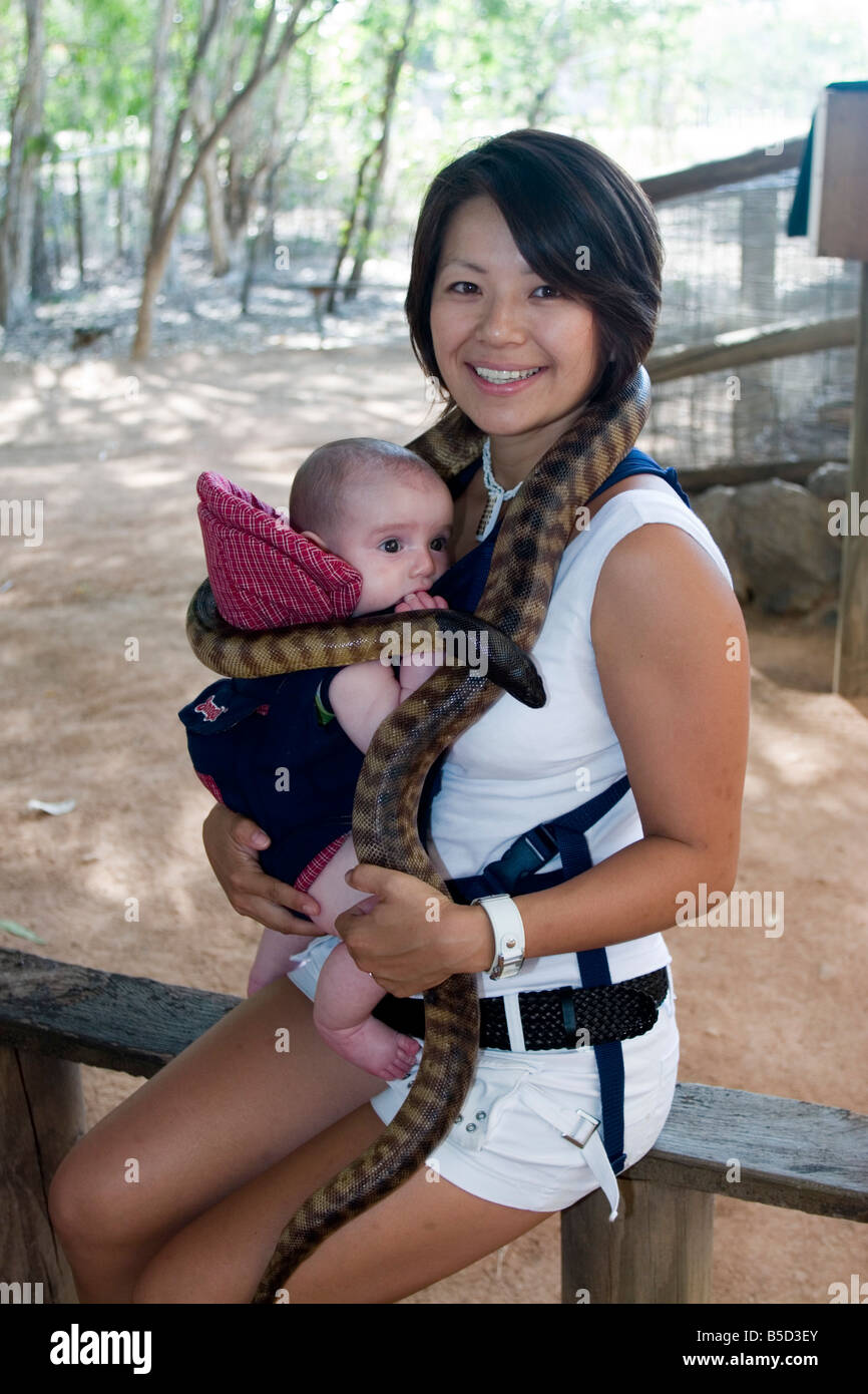 Une Mere Et Bebe Garcon Posent Avec Un Serpent Python Autour Du Cou A Townsville S Billabong Sanctuary Photo Stock Alamy