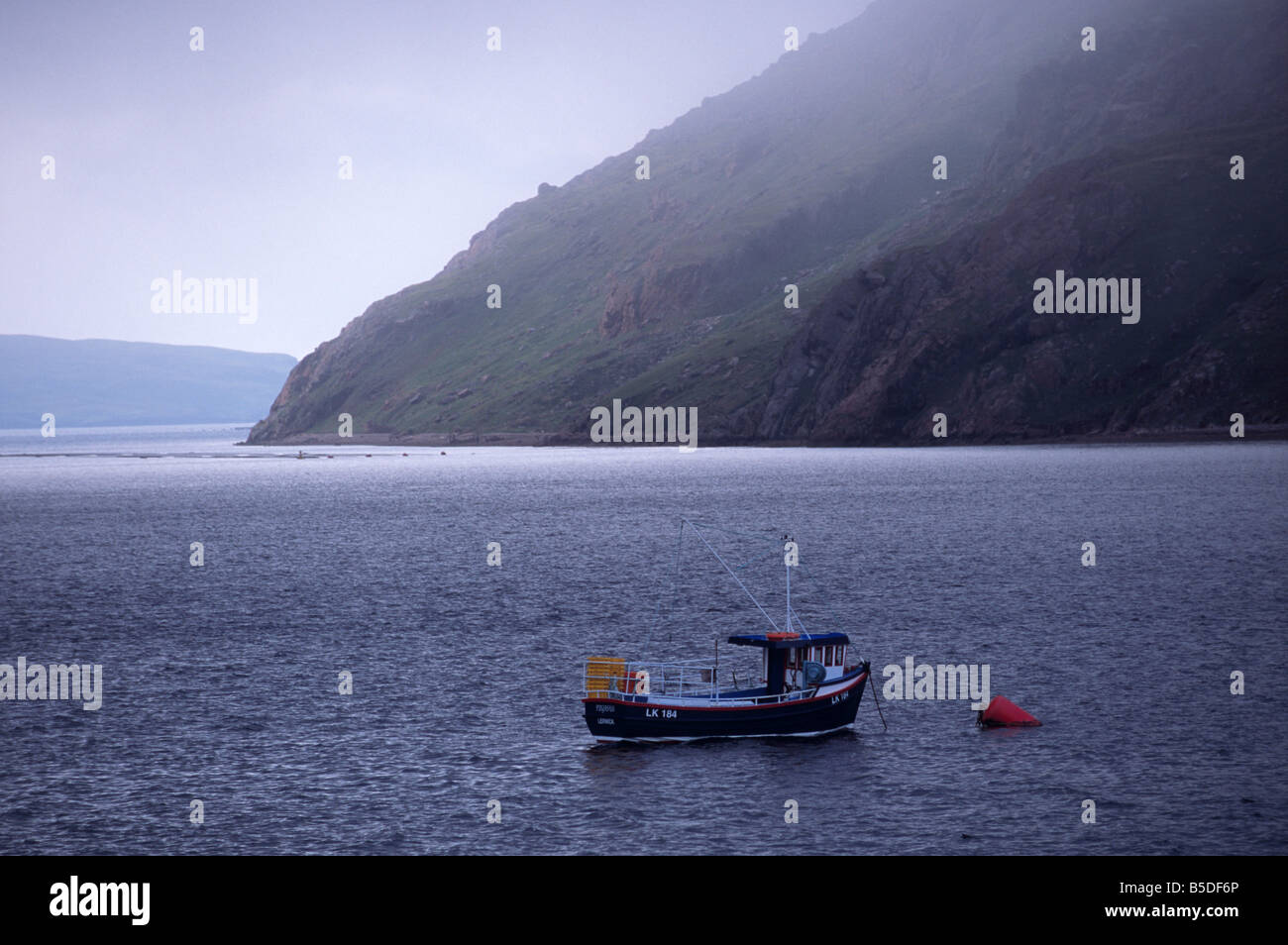 Ronas Voe et bateau de pêche, Ronas Hill les pentes de granit au-dessus, Northmavine, Shetland, Ecosse, Europe Banque D'Images