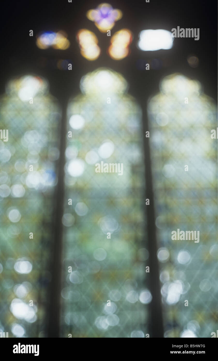 Au début impressionniste diamond-gothique anglais ordinaire au plomb et fenêtre d'or avec la lumière maîtrisée par les arbres à l'extérieur Banque D'Images