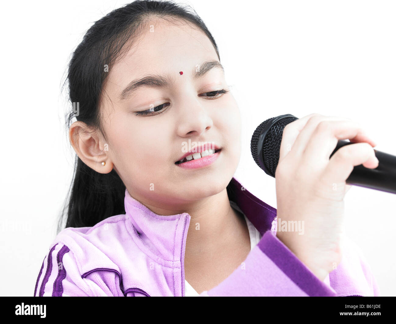 Une jolie fille asiatique à la recherche d'origine indienne dans son chant mike Banque D'Images