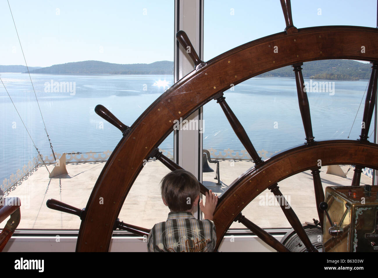 Un petit garçon la roue de direction de direction dans la maison du Showboat Branson belle sur la Table Rock Lake Branson MO Banque D'Images