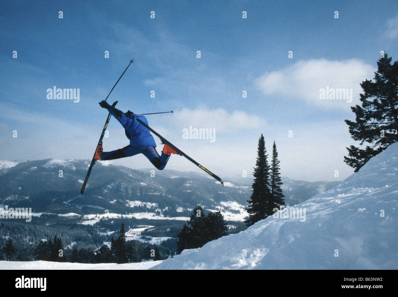 Le skieur s'éteint un saut et fait un Daffy à Bridger Bowl ski area près de Bozeman, Montana, USA Banque D'Images
