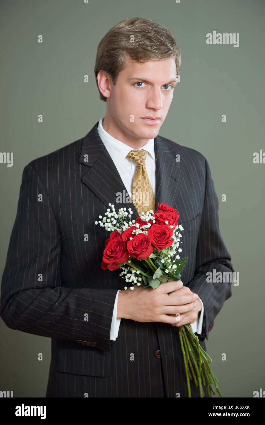 Portrait d'un homme tenant un bouquet de roses Banque D'Images