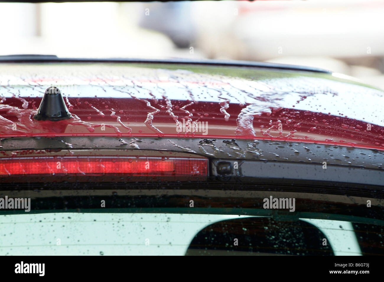 Détail de l'eau perler sur la carrosserie d'un véhicule dans un lave-auto Banque D'Images