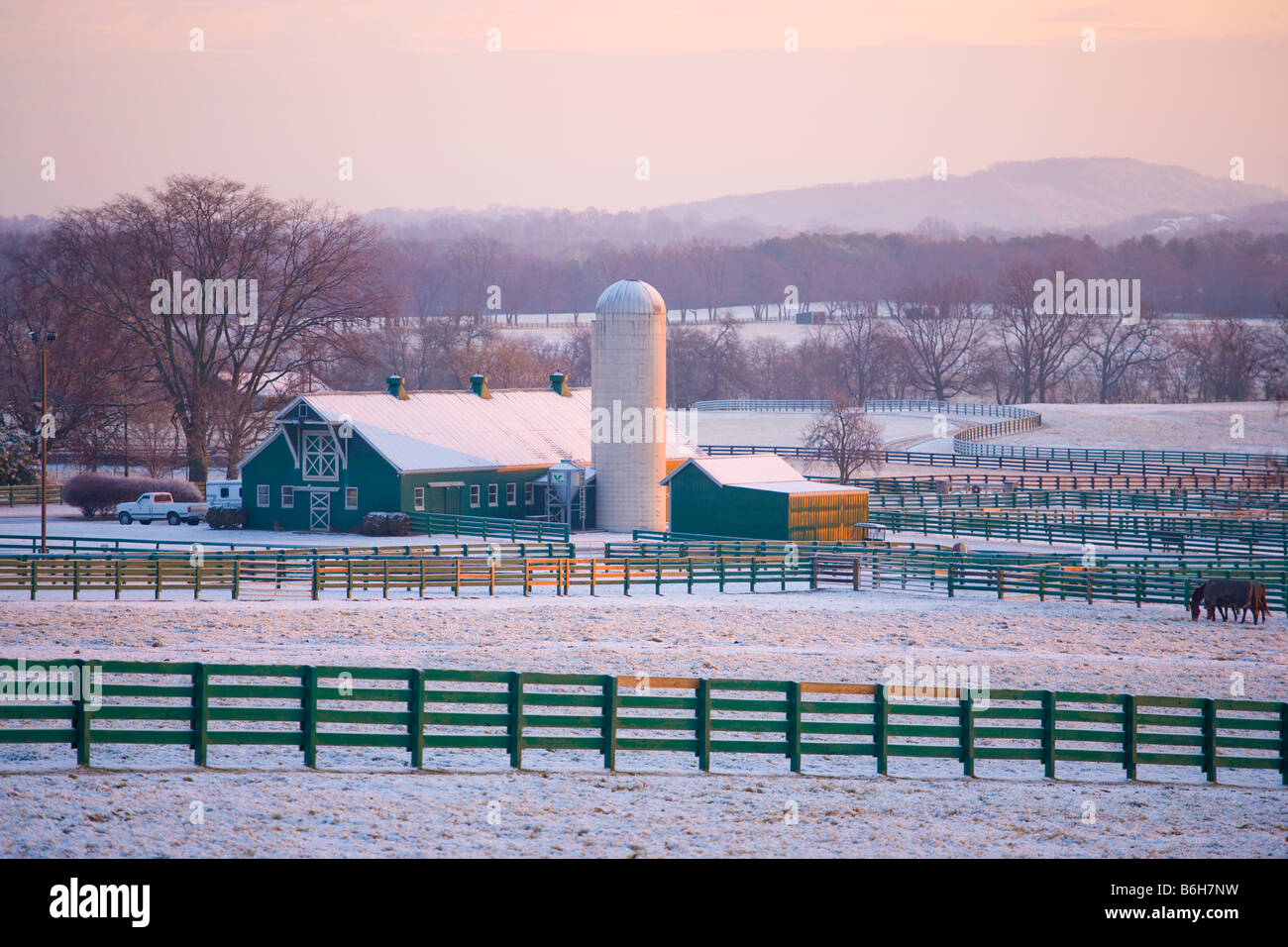 Lever du soleil sur une grange et silo à grains après une chute de neige fraîche, Brentwood, Tennessee Banque D'Images