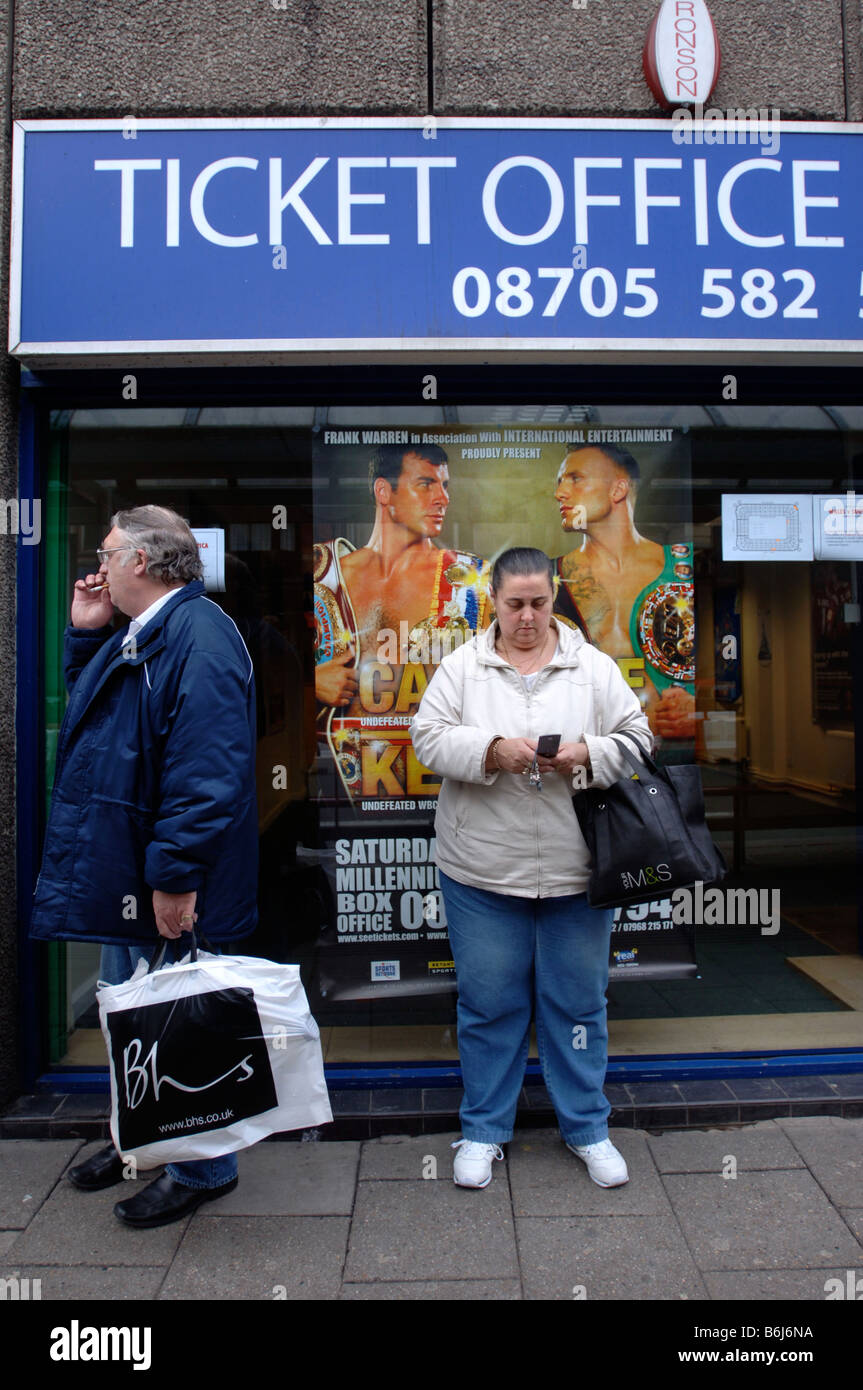 Un CLIENT QUI ATTEND UN BUS EN FACE D'UNE AFFICHE POUR LA LUTTE ENTRE JOE CALZAGHE ET MIKEL KESSLER À CARDIFF S MILLÉNAIRE STAD Banque D'Images