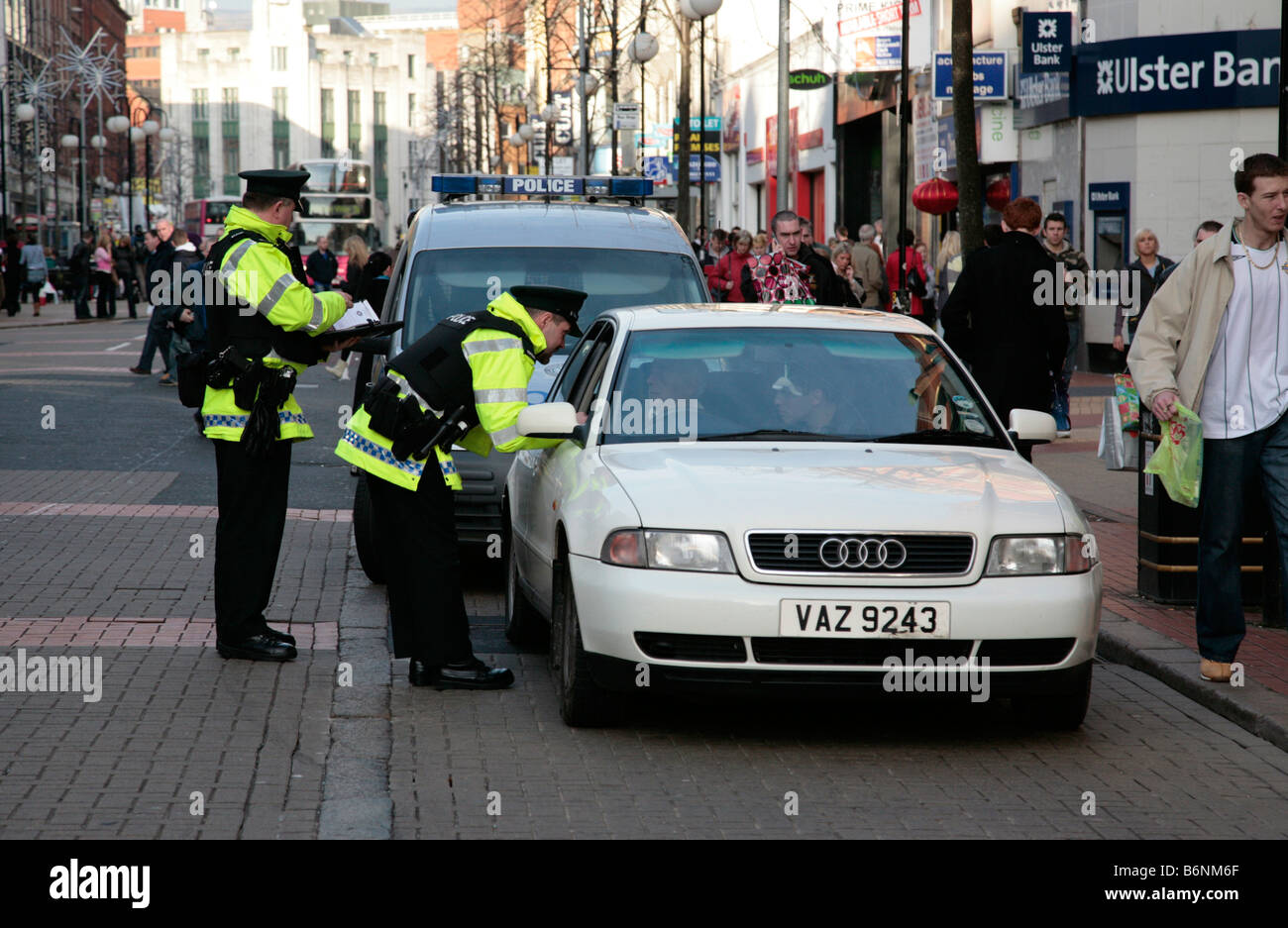 Question de la police un conducteur d'une voiture Audi dans un contrôle de routine dans une zone piétonne du centre-ville de Belfast Royaume-Uni Banque D'Images