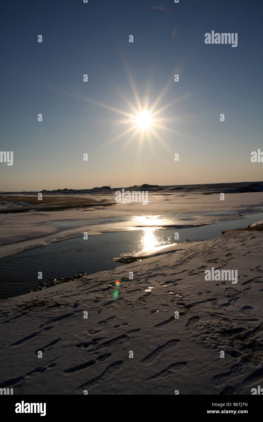 Empreintes de pas sur la feuille de la fonte des glaces sur le lac Michigan près de Sunset Banque D'Images