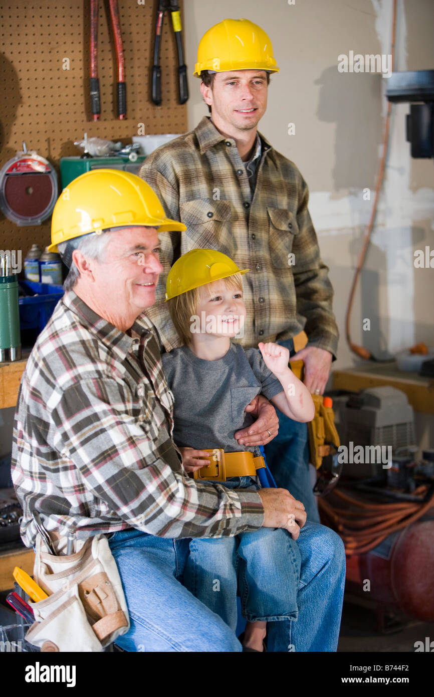 Multi-generation family wearing hardhats Banque D'Images