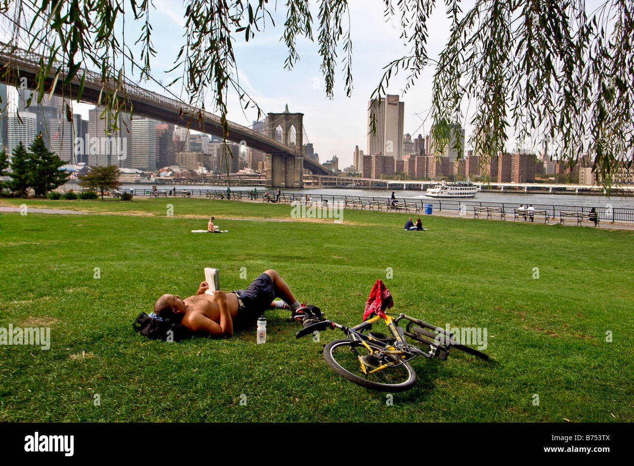 Man reading a book in pont de Brooklyn Park, New York, USA Banque D'Images