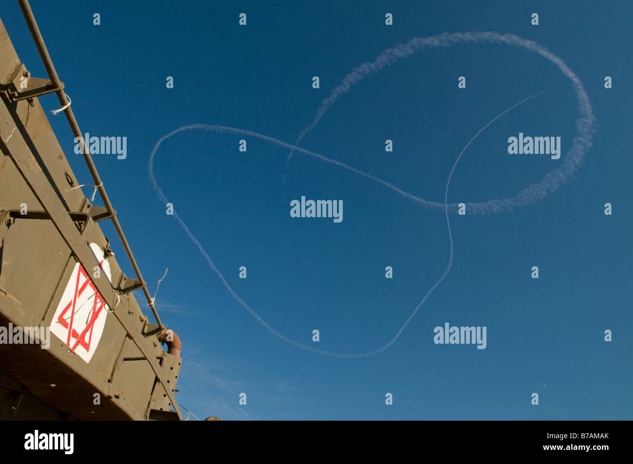 La fumée des avions israéliens laissent des traces dans le ciel avec APC blindés à la frontière israélienne avec la bande de Gaza Banque D'Images