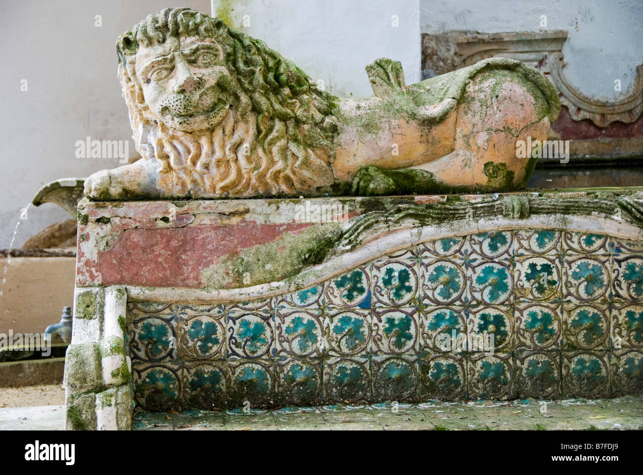 Dans le jardin du Palais national (Palais national), Sintra, Portugal. Un siège décoré de tuiles (azulejos) avec une sculpture de lion Banque D'Images
