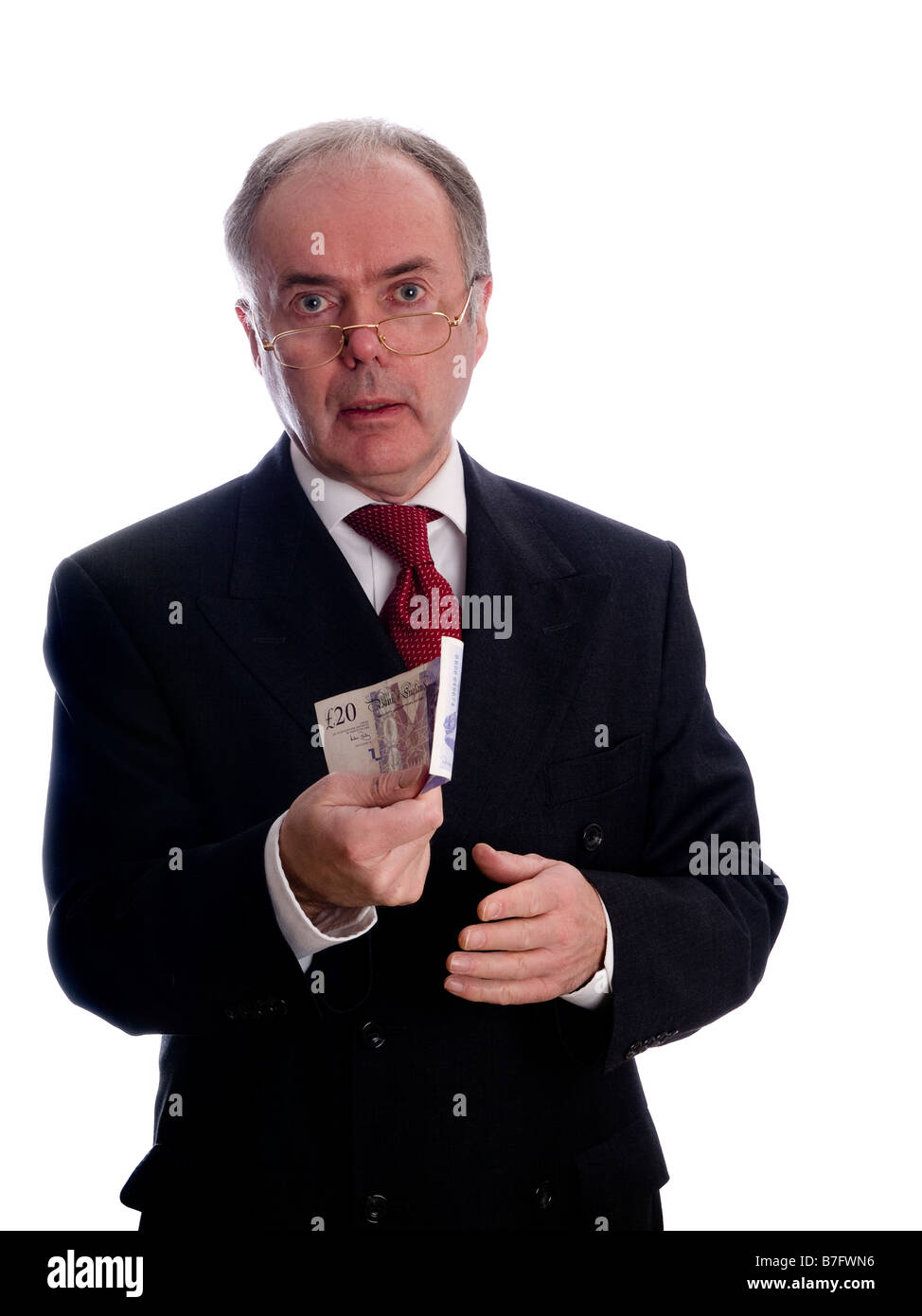 Homme d'affaires ou professionnel portant costume et cravate et conserver l'argent sterling £20 Banque D'Images