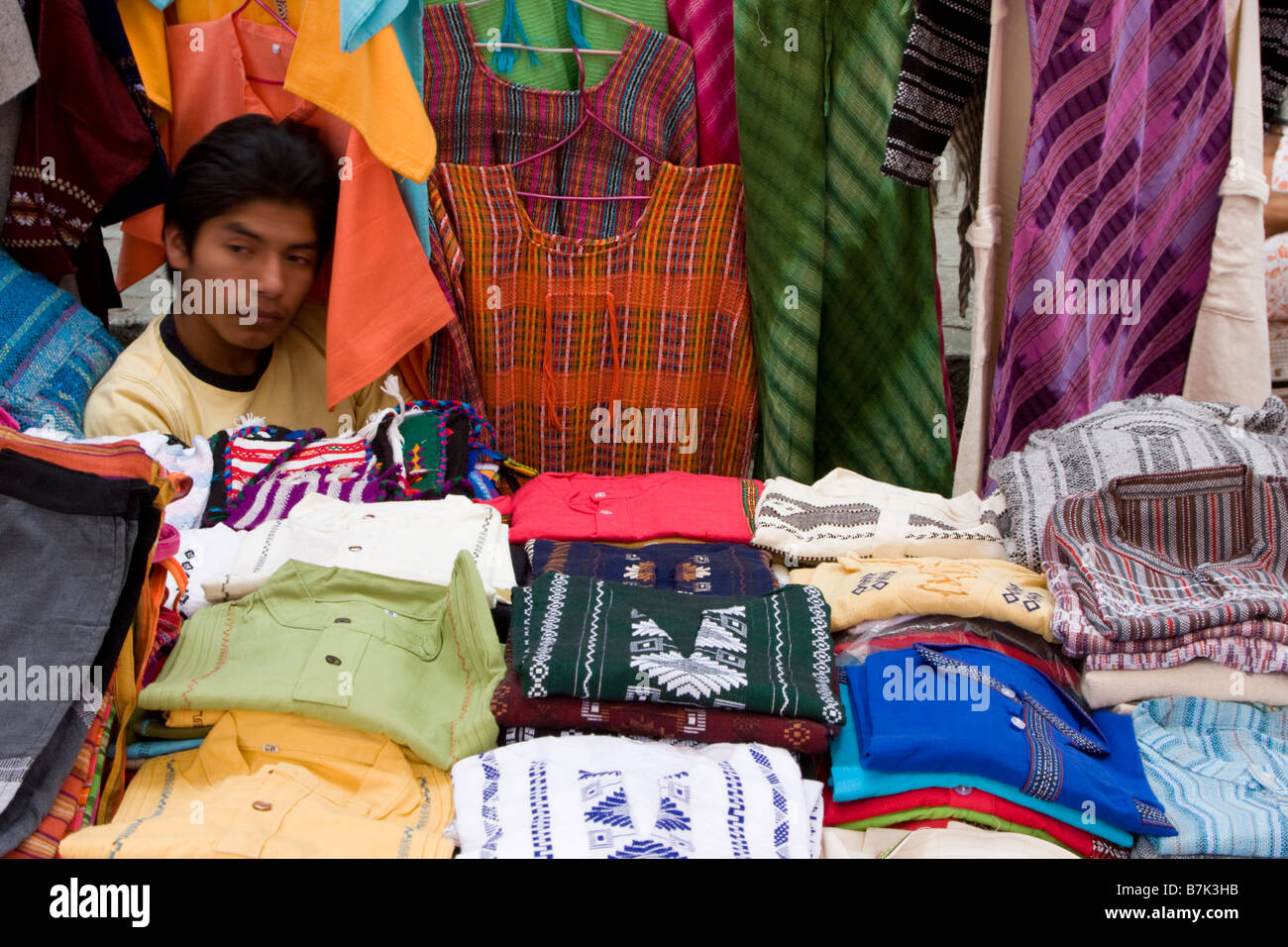 Oaxaca, Mexique. Vendeur de vêtements, marché plein air, Plazuela Labastida, près de l'église de Santo Domingo. Banque D'Images