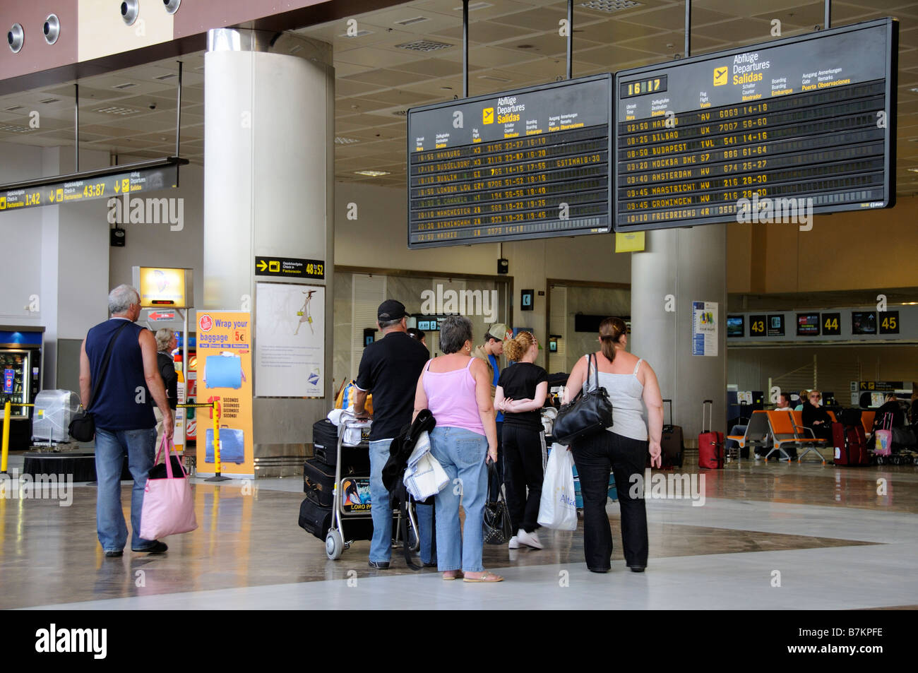 Les départs de l'aérogare passagers conseil les hommes et les femmes à l'Aéroport Reina Sofia dans le sud de Tenerife Banque D'Images