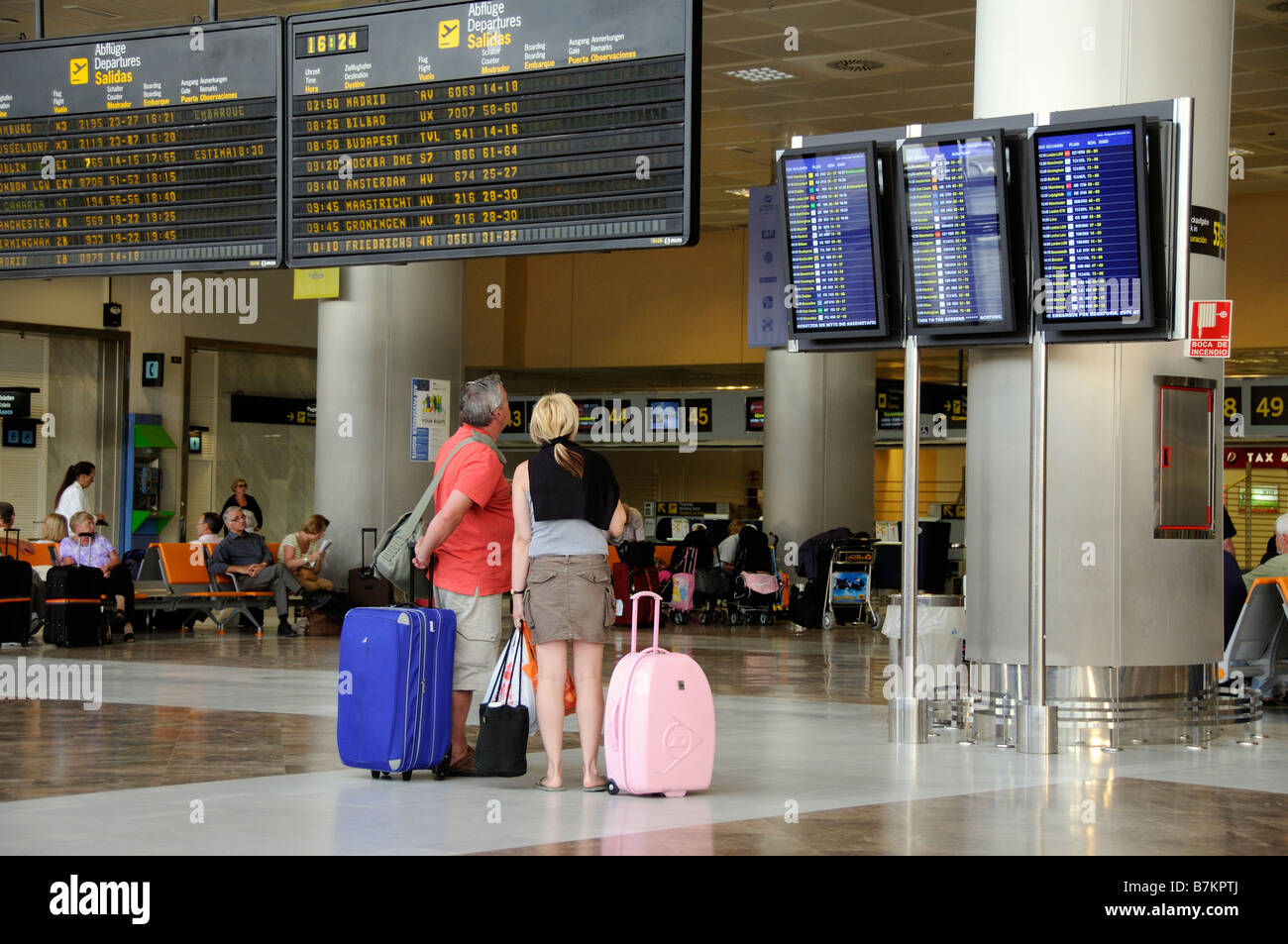 Les départs de l'aérogare passagers conseil homme femme à l'Aéroport Reina Sofia au sud de Tenerife Banque D'Images