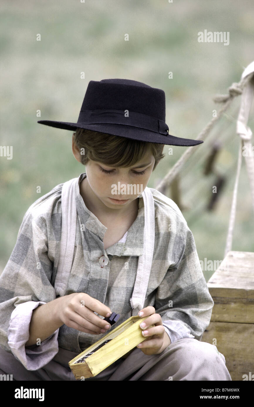 Un jeune garçon en habits d'époque jouer jeux domino à une guerre civile à la reconstitution Wade House Greenbush au Wisconsin Banque D'Images