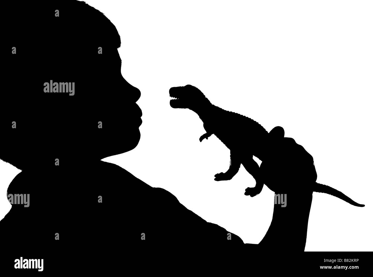 Silhouette de garçon à la recherche d'un dinosaure à Banque D'Images