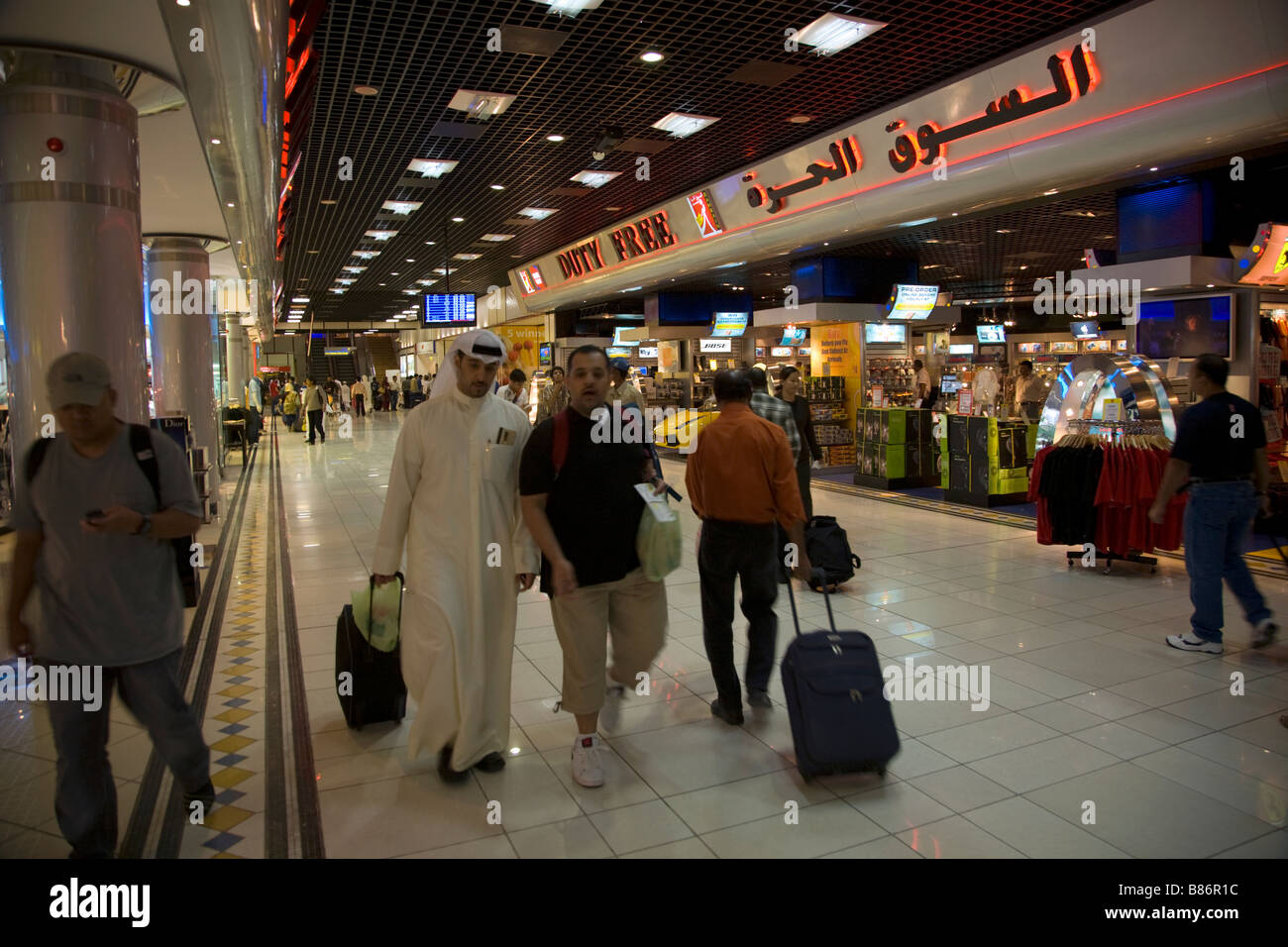 Les passagers dans une salle de départ à l'extérieur de la boutique hors taxes. L'aéroport de Bahreïn. Banque D'Images