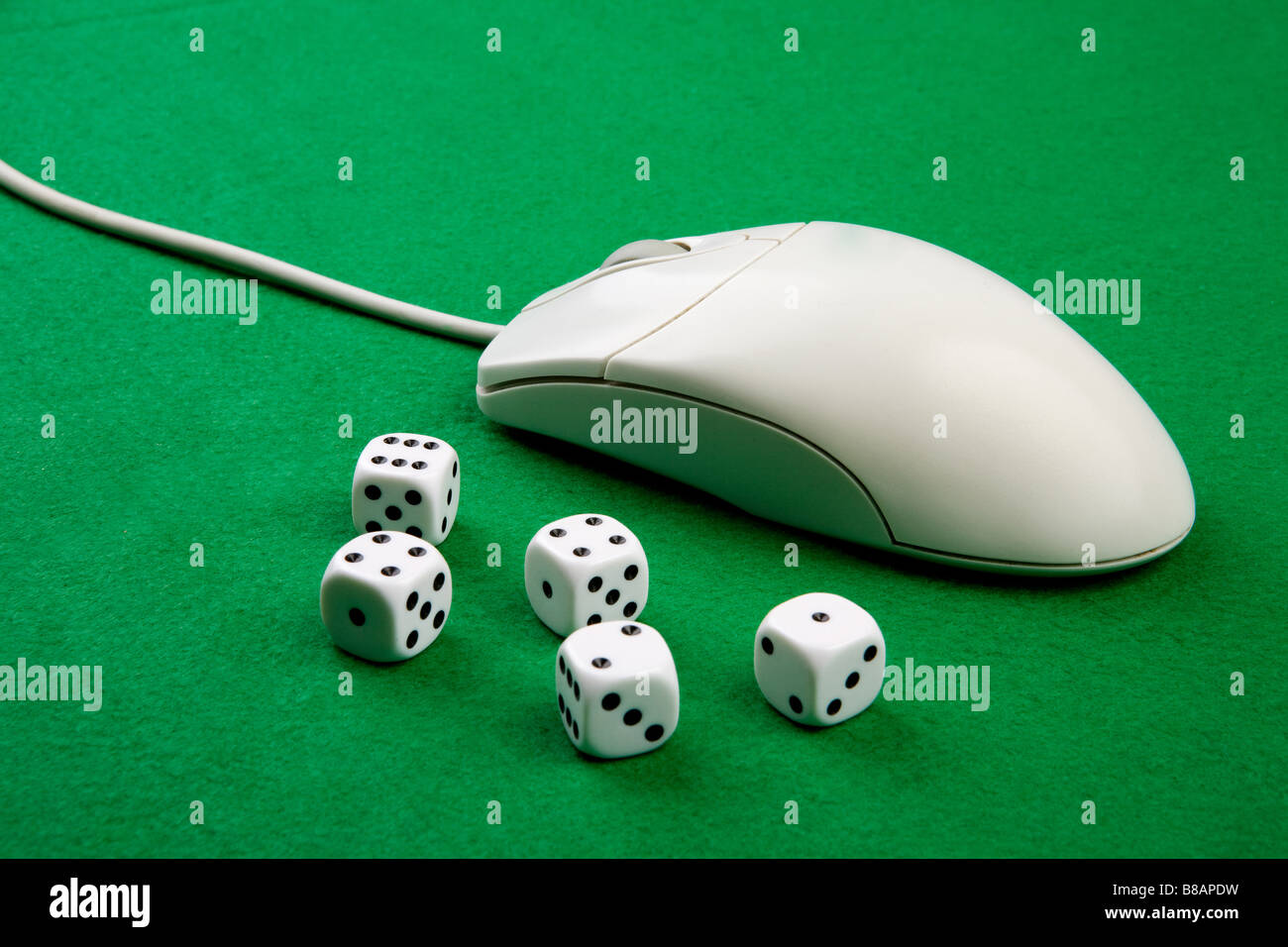 Dés et une souris d'ordinateur sur un fond vert concept de jeu en ligne Banque D'Images