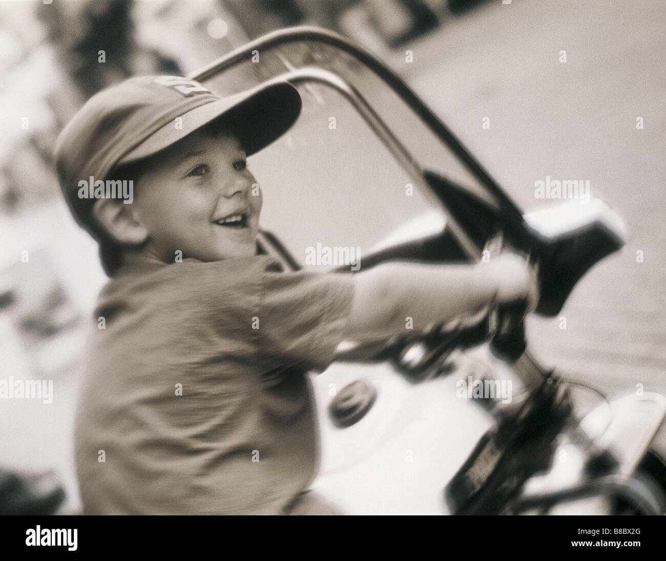 FL4935, Matthew Plexman ; Boy Riding Moto jouet, P.C. Banque D'Images