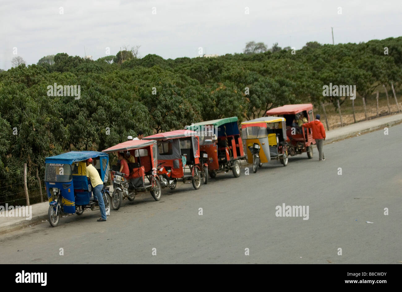 Six Tricycles 6 mobylettes garées dans une rangée à Puerto Lopez, Équateur, Amérique du Sud 72492 Équateur Banque D'Images