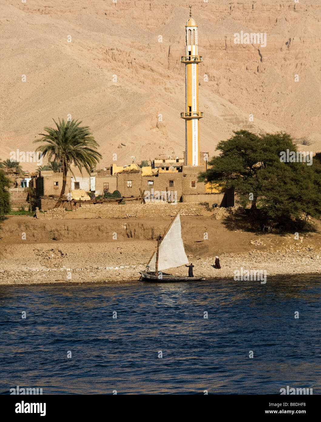 En felouque Nil avec des maisons et de la mosquée sur le côté de la rivière. Banque D'Images