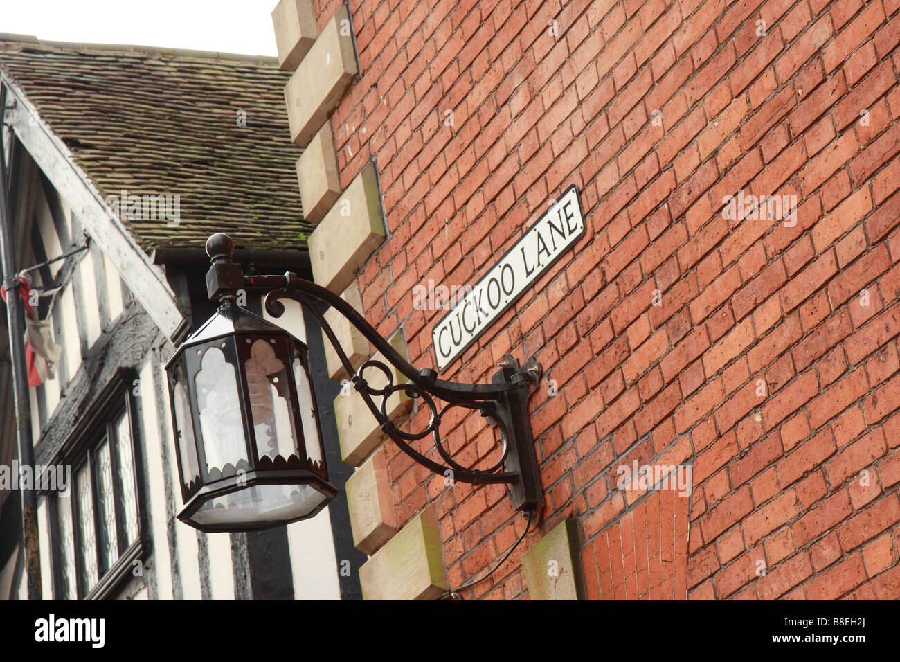 Nom de la route de Cucoo Lane sur un coin de rue sur un mur de briques Banque D'Images