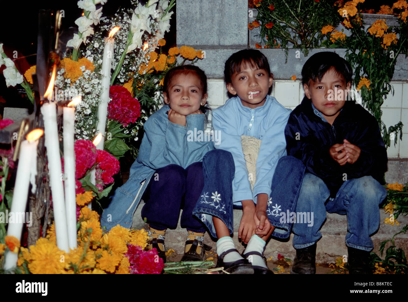 Enfants à la tombe, lors de Fiesta de muertos au cimetière du village dans près de Oaxaca Xoxocotlan Mexique Banque D'Images