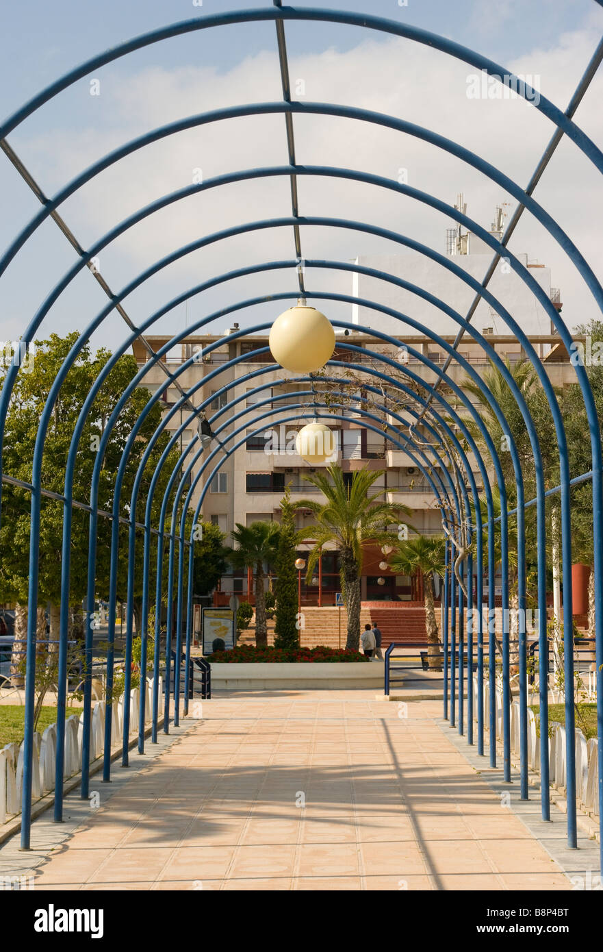 Piétons avec arch arches cintrées tubulaires métalliques de la structure de fleurs grimpantes Santa Pola Espagne Banque D'Images