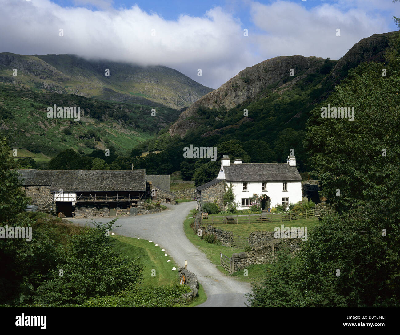 Une vision à long terme de Yew Tree Farm Coniston Cumbria Lake District avec l'agriculteur et un troupeau de moutons Herdwick dans la cour Banque D'Images