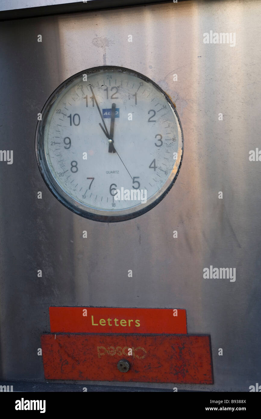 Un scellé post box avec une horloge au-dessus à l'avant d'un bureau de poste, à fermer ses portes Banque D'Images