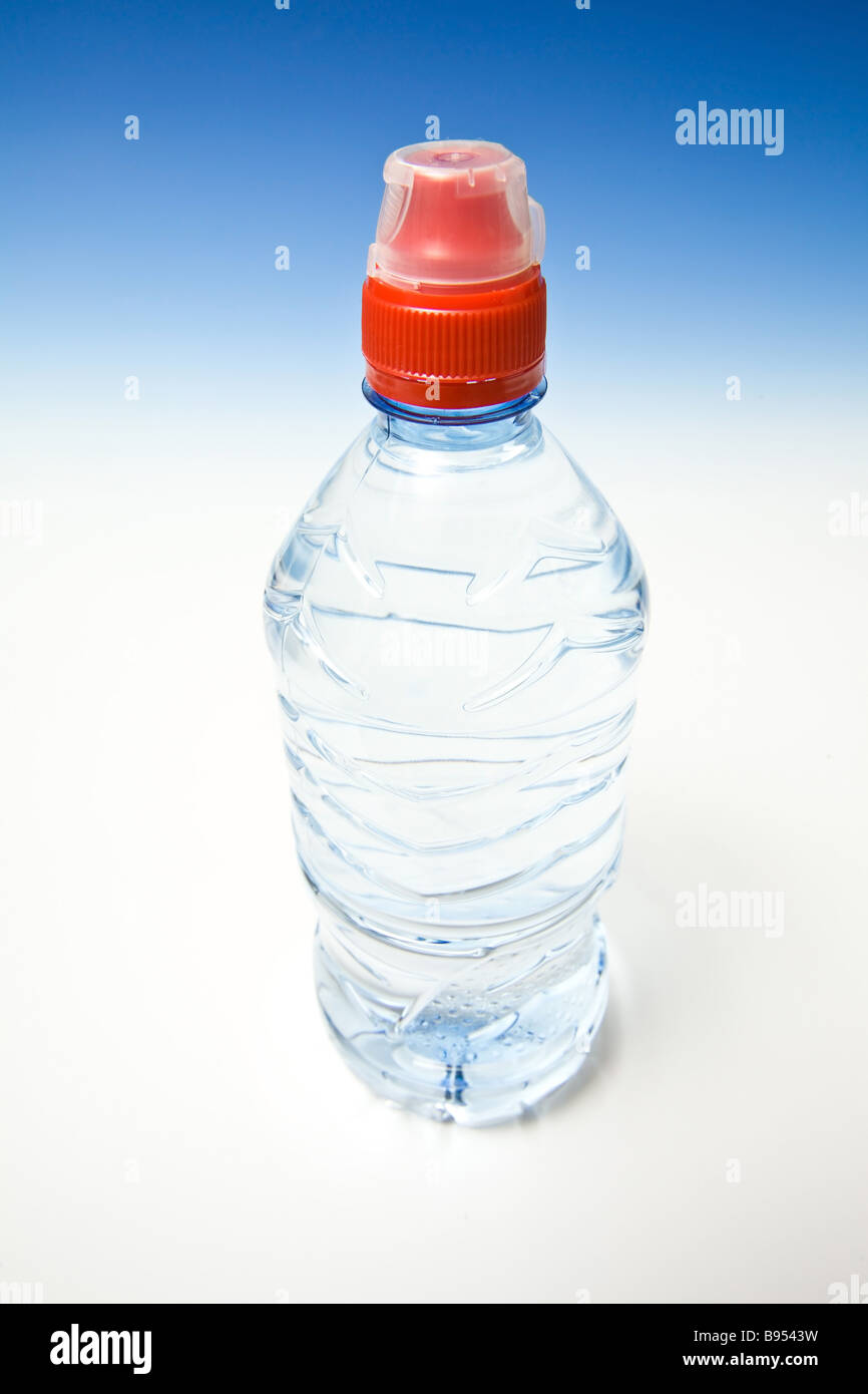 L'eau en bouteille sur un fond bleu dégradé studio Banque D'Images