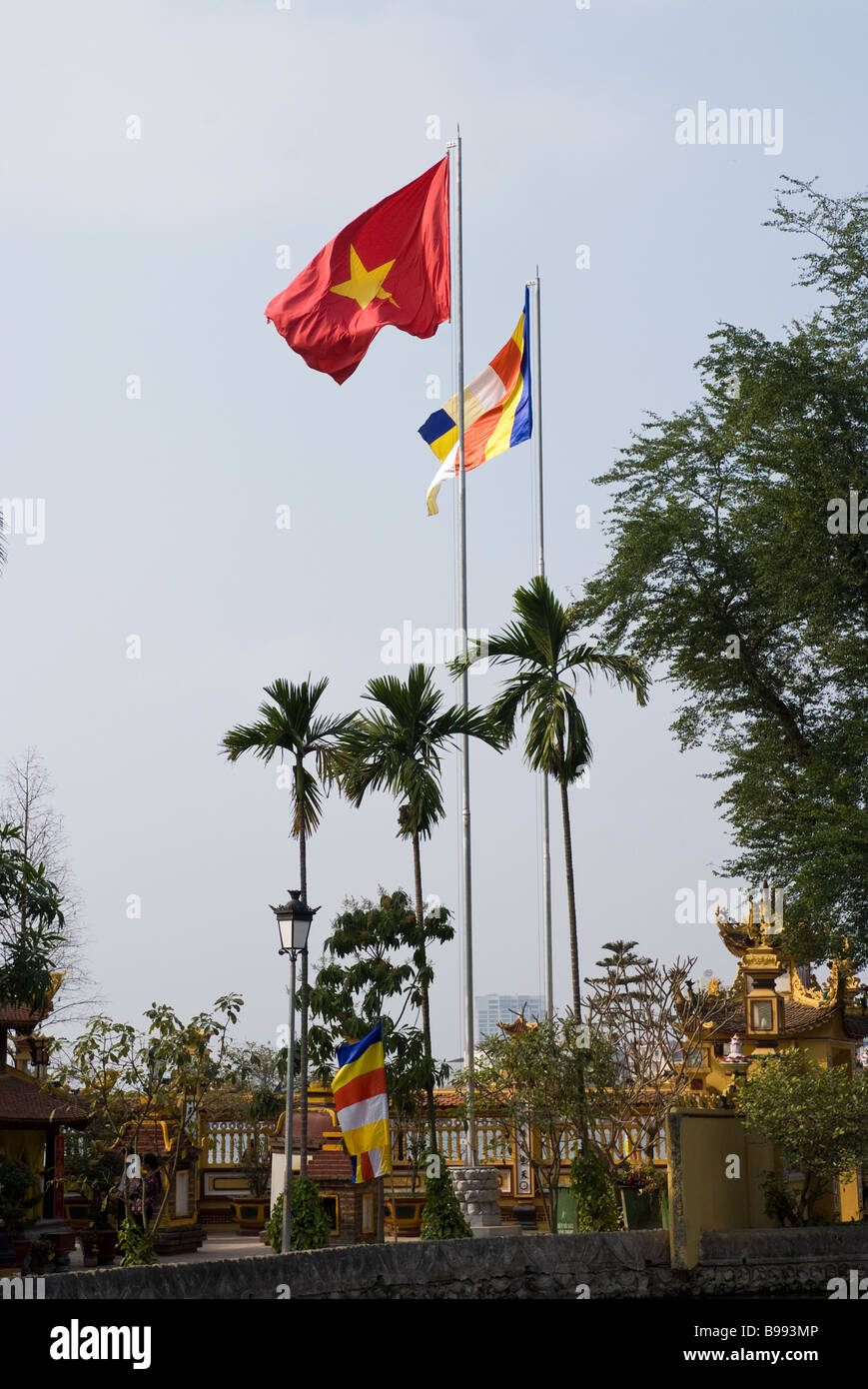 Les Vietnamiens et les drapeaux religieux à la Pagode Tran Quoc à Hanoi Vietnam Banque D'Images
