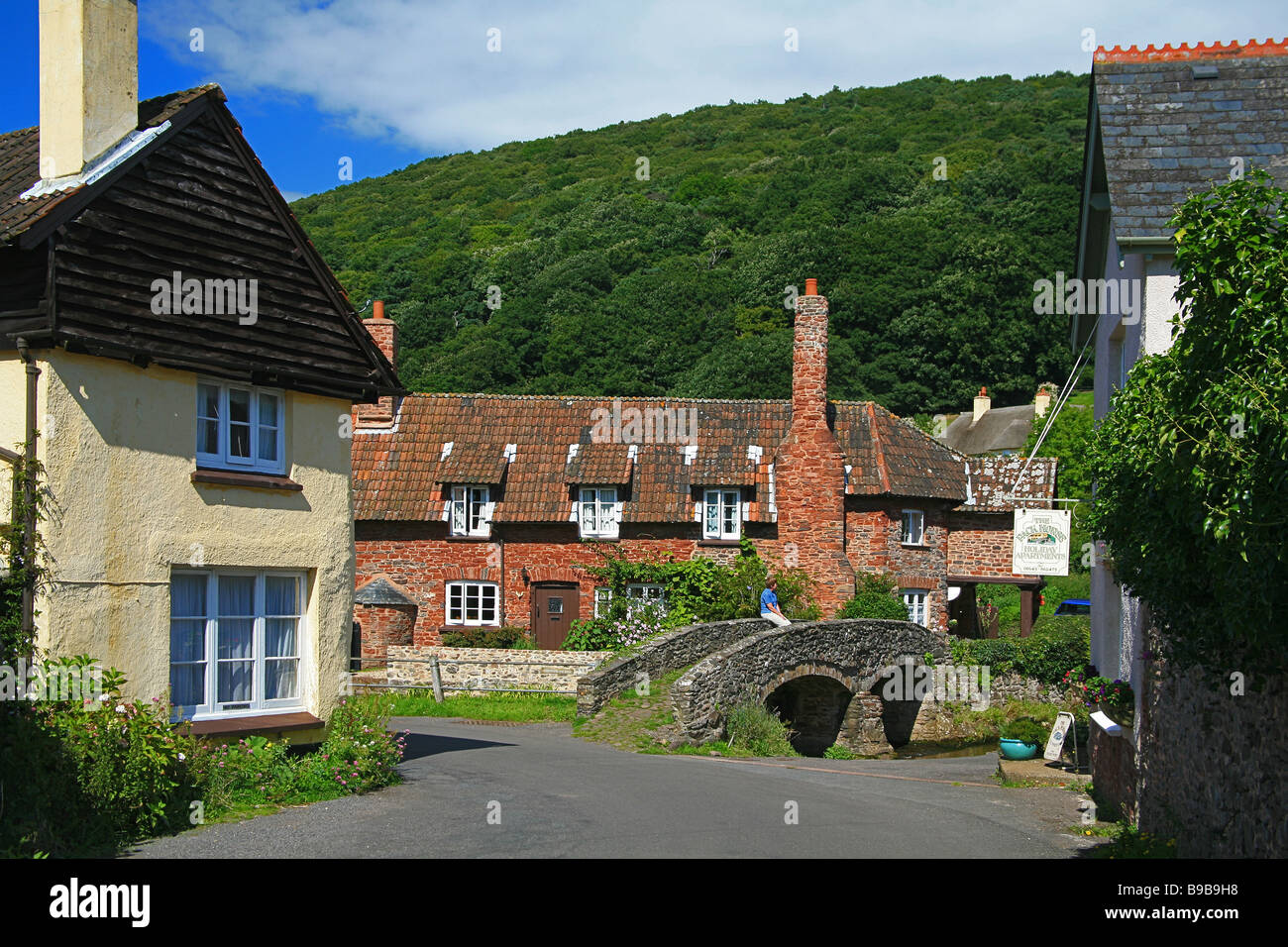Chalets traditionnels en pierre et pack horse bridge dans le village de Allerford, Somerset, England, UK Banque D'Images
