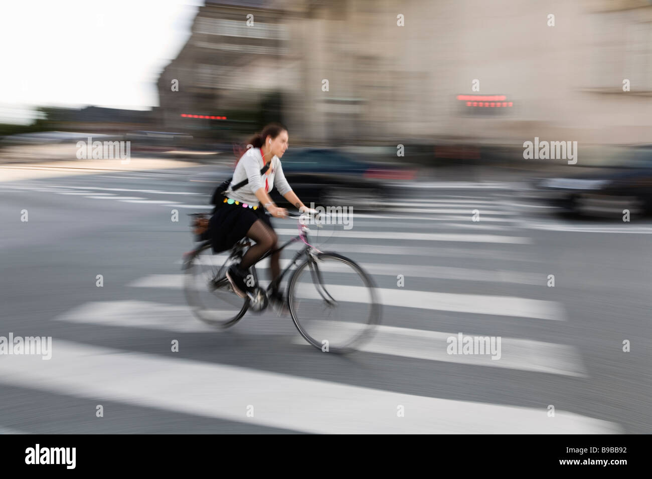Copenhague, Danemark. Young woman riding bicycle in city center Banque D'Images