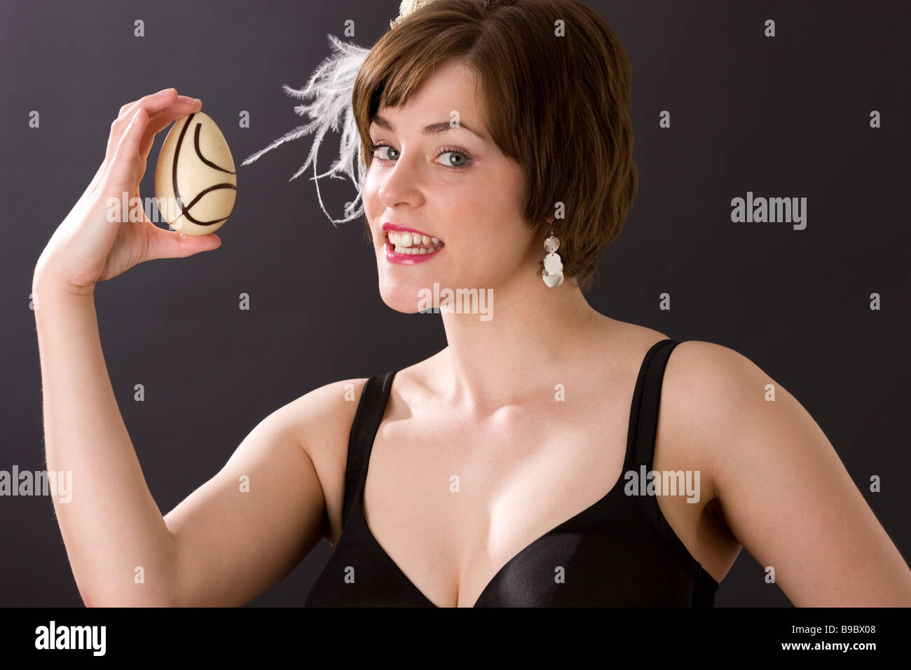 Girl in bra holding easter egg and smiling Banque D'Images