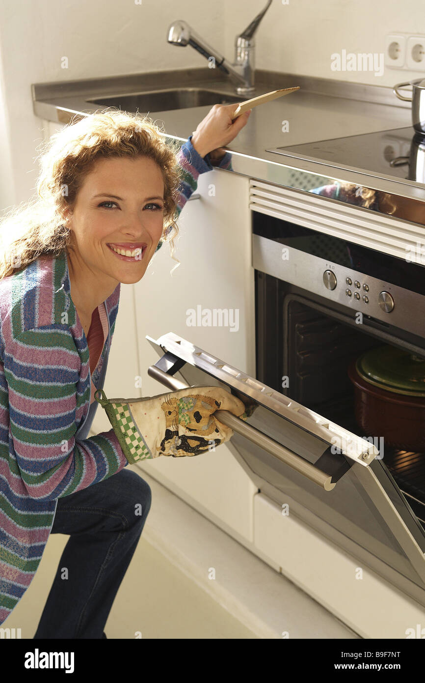 Femme cuisine four ouvre l'air série détail personnes ménagère hobby-cuire  au four rire blonde porte ouvre la casserole fait-tout Photo Stock - Alamy