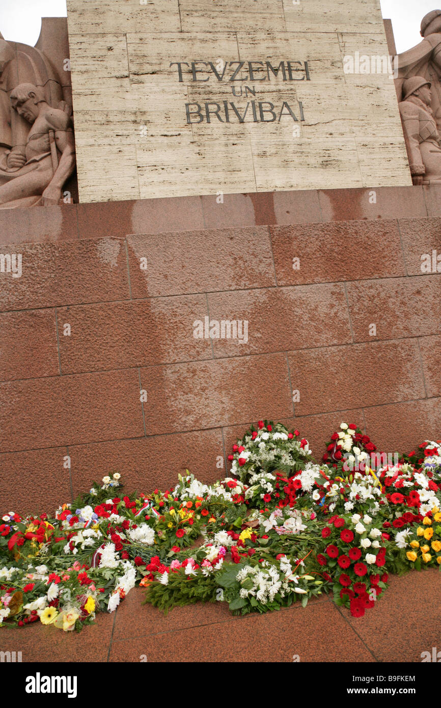 Fleurs autour de la base du monument de la liberté ou des Milda, Riga, Lettonie. Banque D'Images