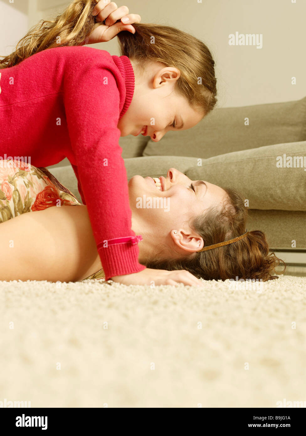 Mother and Daughter lying on floor Banque D'Images