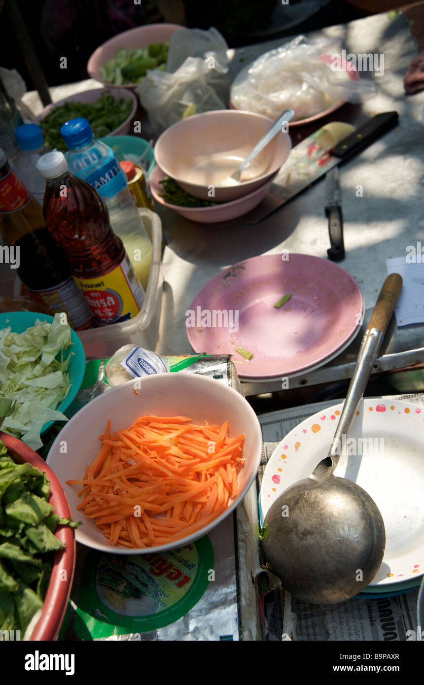 Gros plan de carottes fraîches râpées dans un bol et des bols à nourriture sur un stand de rue Bangkok Thaïlande Banque D'Images