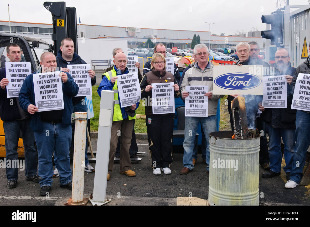 Démontrer les travailleurs contre les licenciements à une usine de Ford par holiding des affiches de demander de l'aide. Banque D'Images