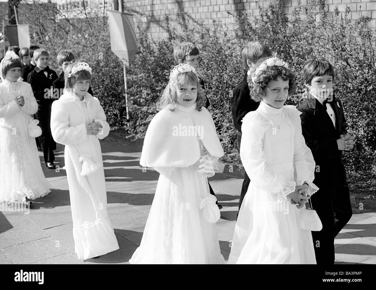 Années 1980, photo en noir et blanc, la religion, le christianisme, la première communion, les filles en communion robes et les garçons à pied dans une procession à l'église, âgés de 8 à 12 ans, Christina Banque D'Images