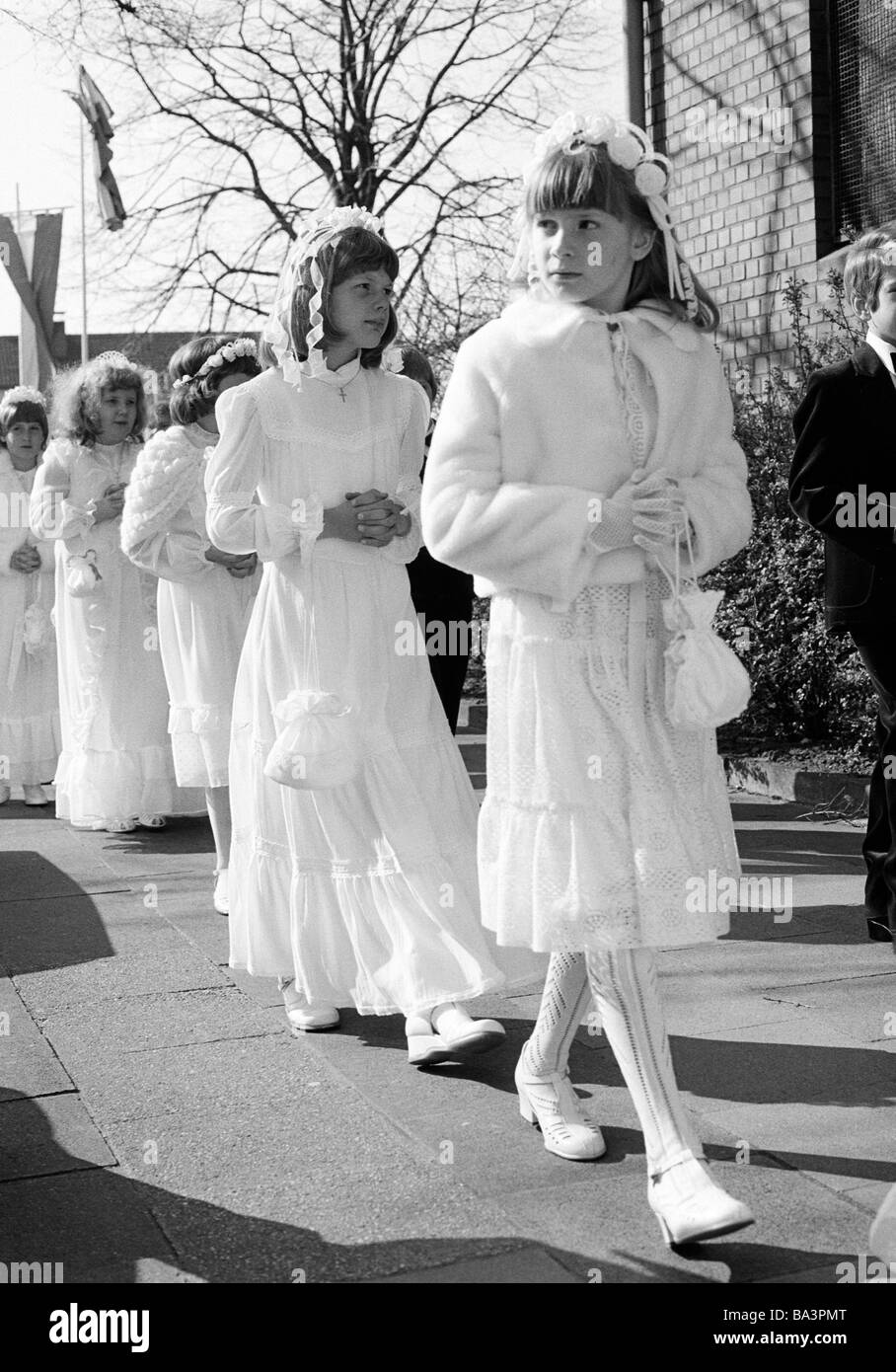 Années 1980, photo en noir et blanc, la religion, le christianisme, la première communion, les filles en robe de communion à pied dans une procession à l'église, âgés de 8 à 12 ans Banque D'Images