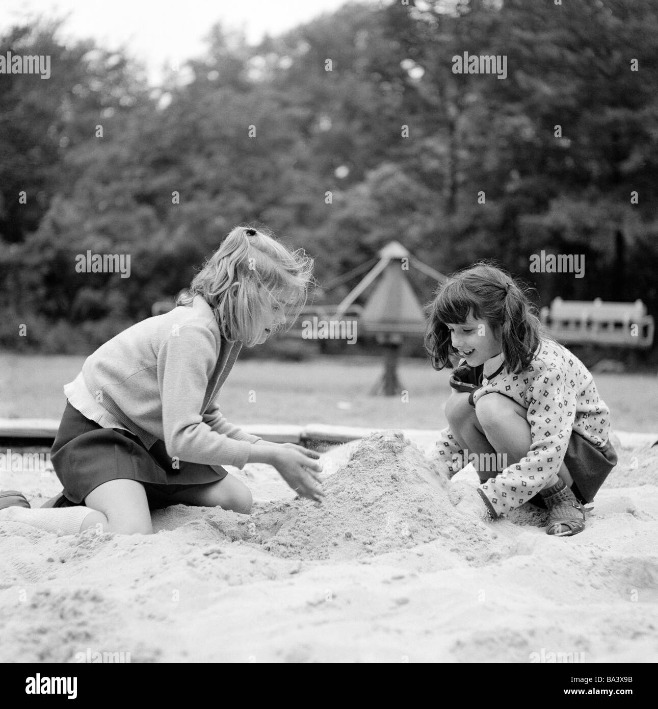 Années 70, photo en noir et blanc, les gens, les enfants, deux petites  filles jouant dans un bac à sable, aire de jeux pour enfants, âgés de 4 à 6  ans Photo Stock - Alamy