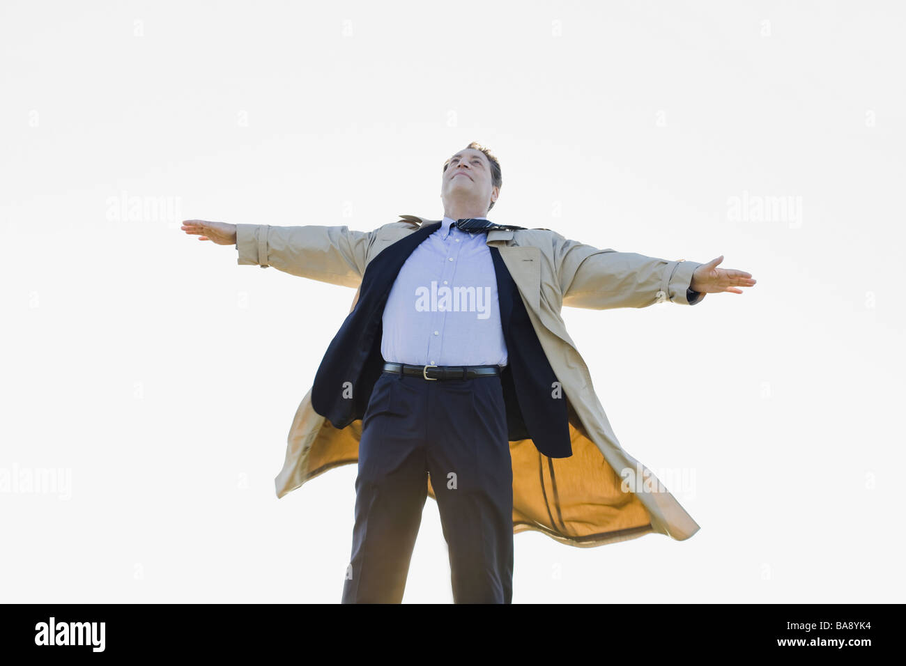 Businessman standing in wind Banque D'Images