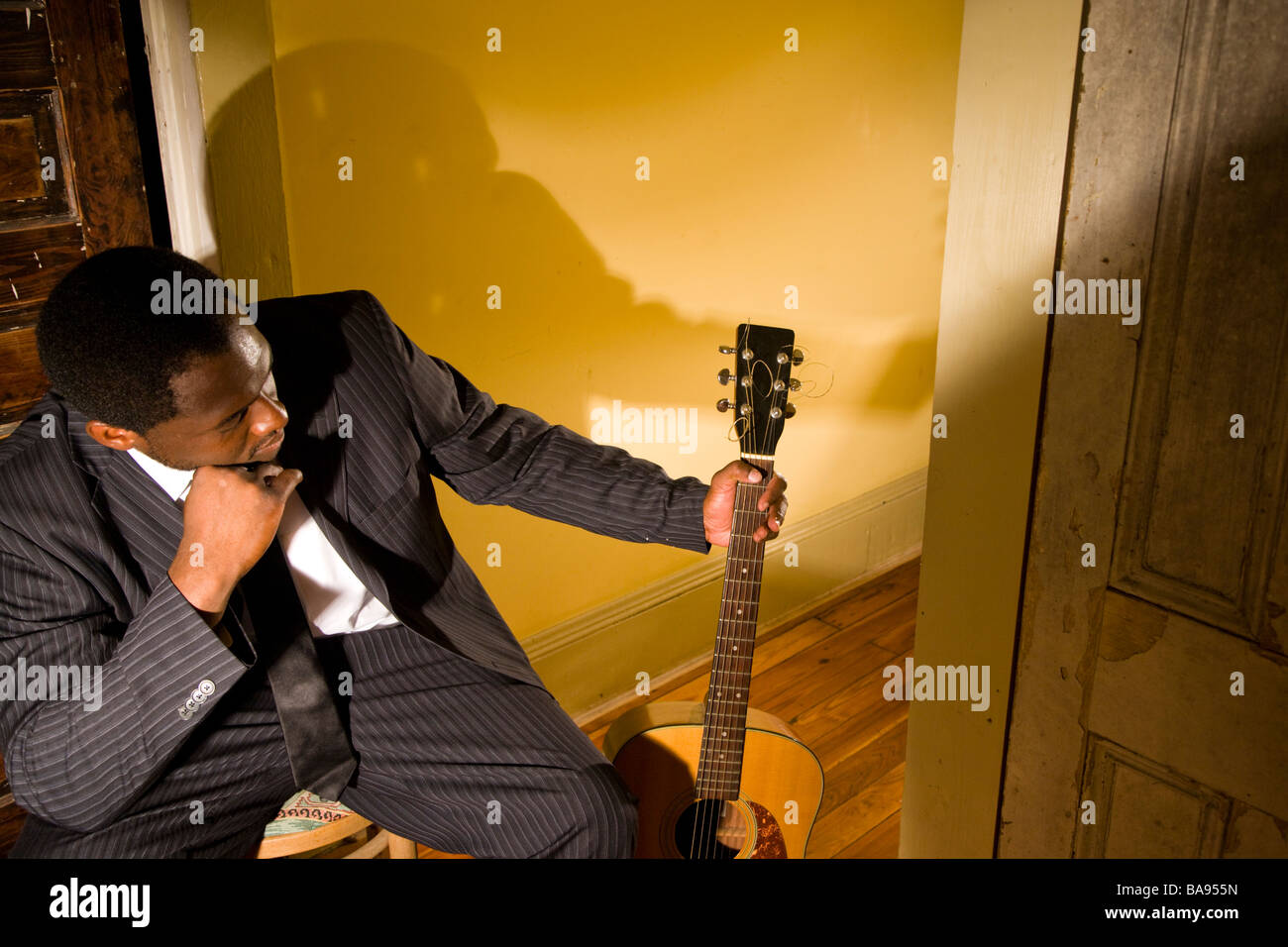 Portrait de musicien afro-américain dans le couloir avec guitare Banque D'Images