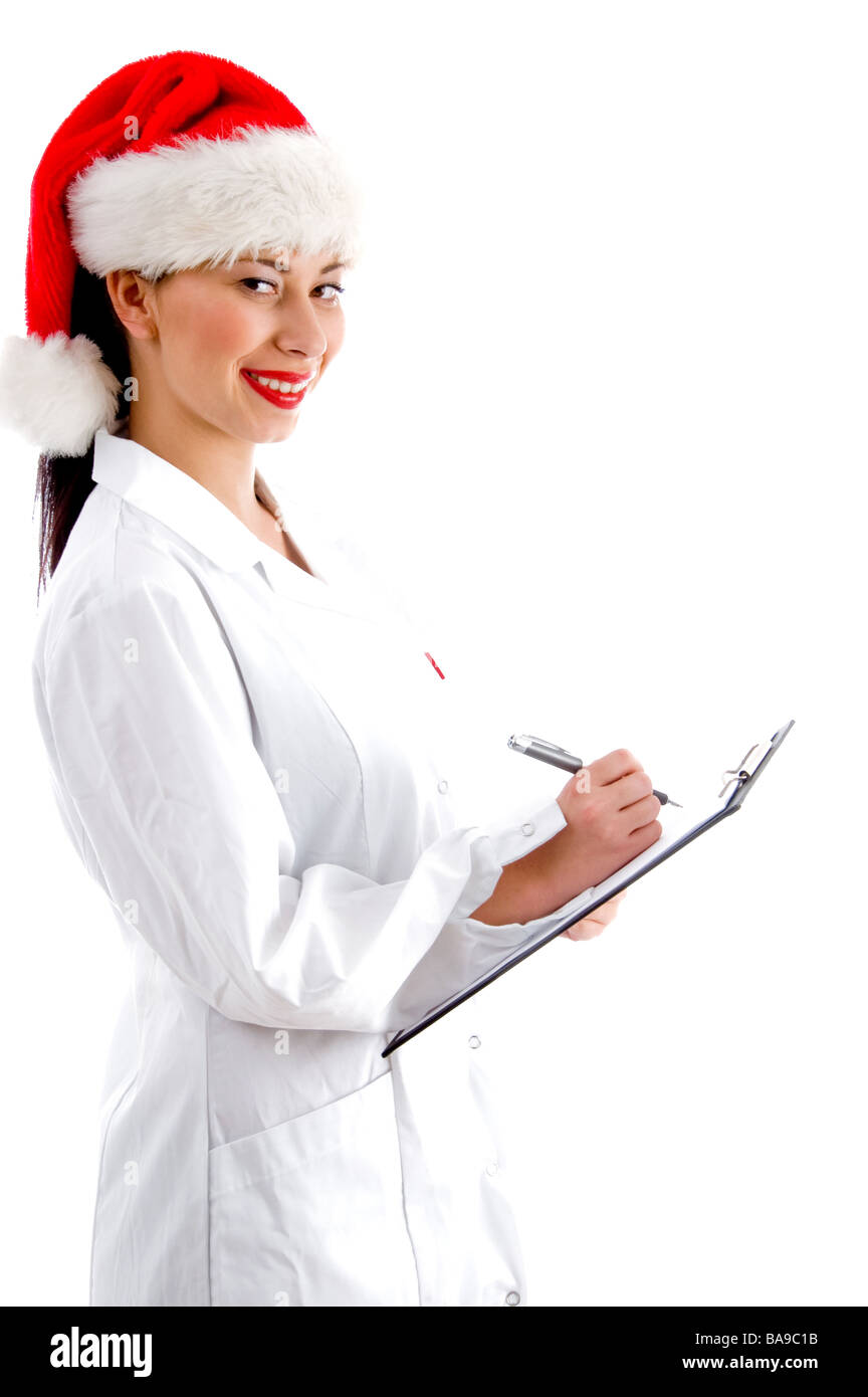 Smart doctor wearing christmas hat et holding clipboard Banque D'Images