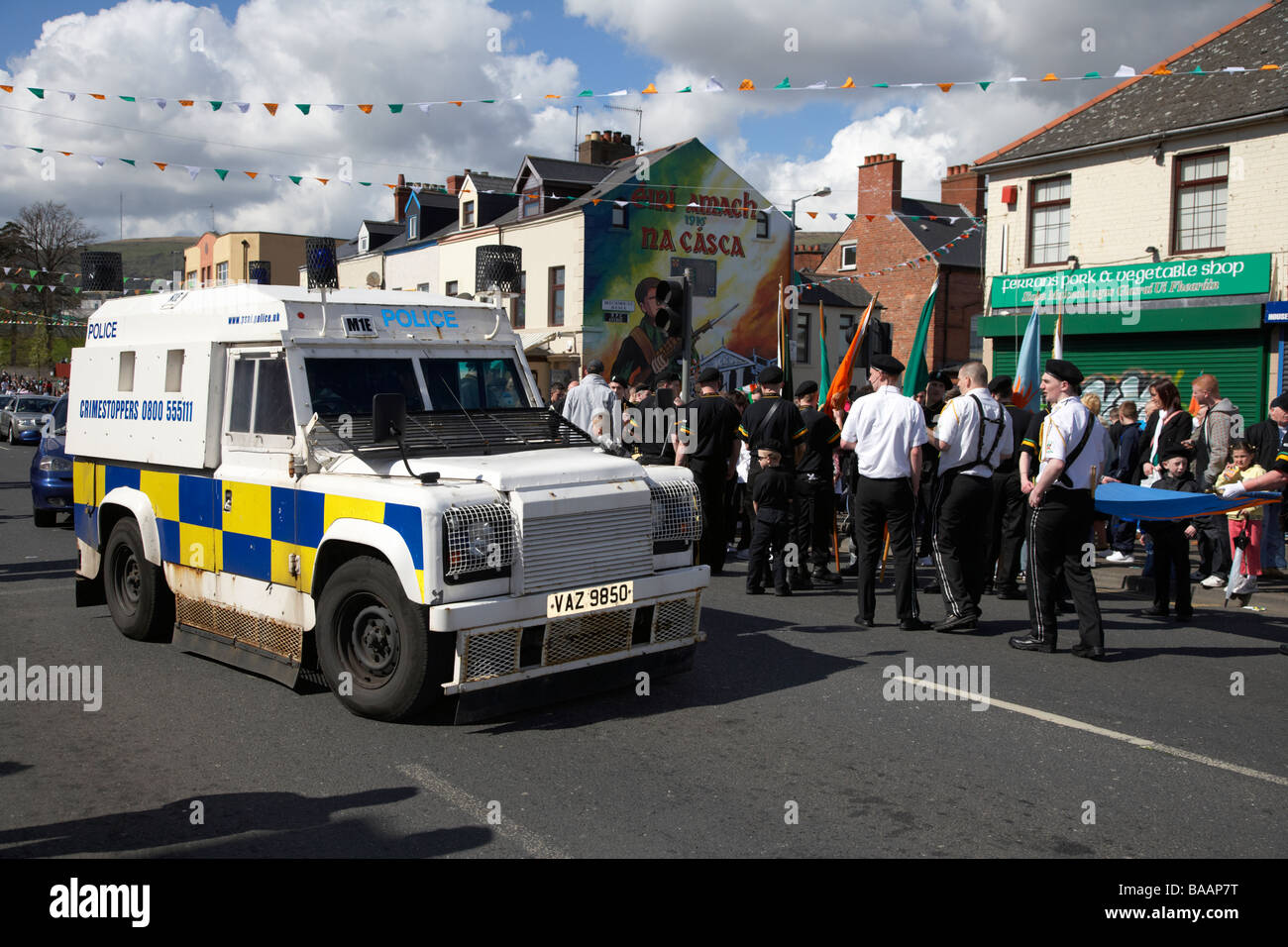 Émeute PSNI landrover passe les membres de l'Eire nua flûte républicaine mars bande en bas de la falls road le dimanche de Pâques Banque D'Images