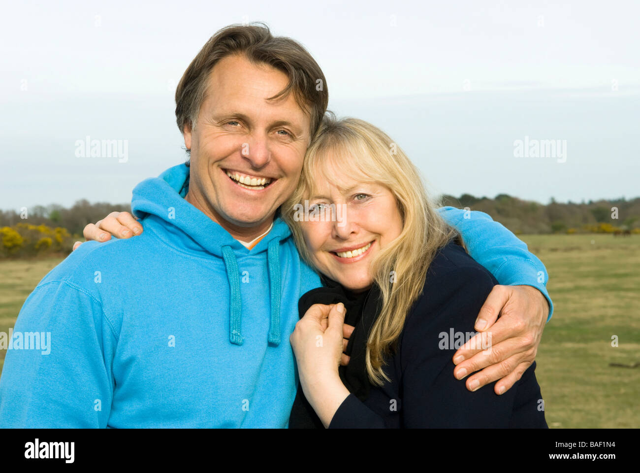 Un beau 40 fils de câlins jusqu'à sa belle mère des années 60 au cours d'une journée dans la campagne. Banque D'Images